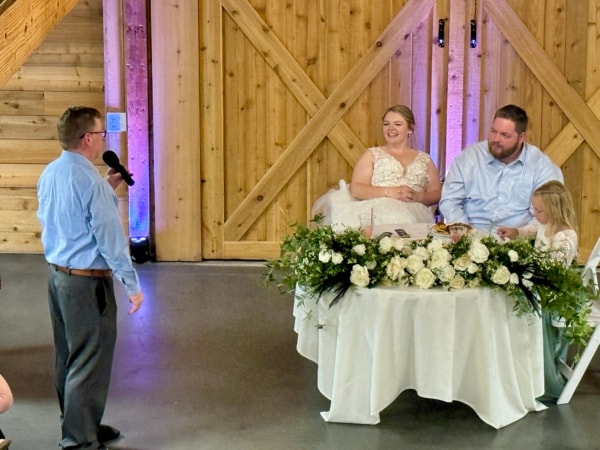Messer-Hannah couple with their DJ at The Barn on 400